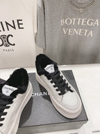 Women’s Chanel sneakers, white leather uppers with black laces and faux-fur collar