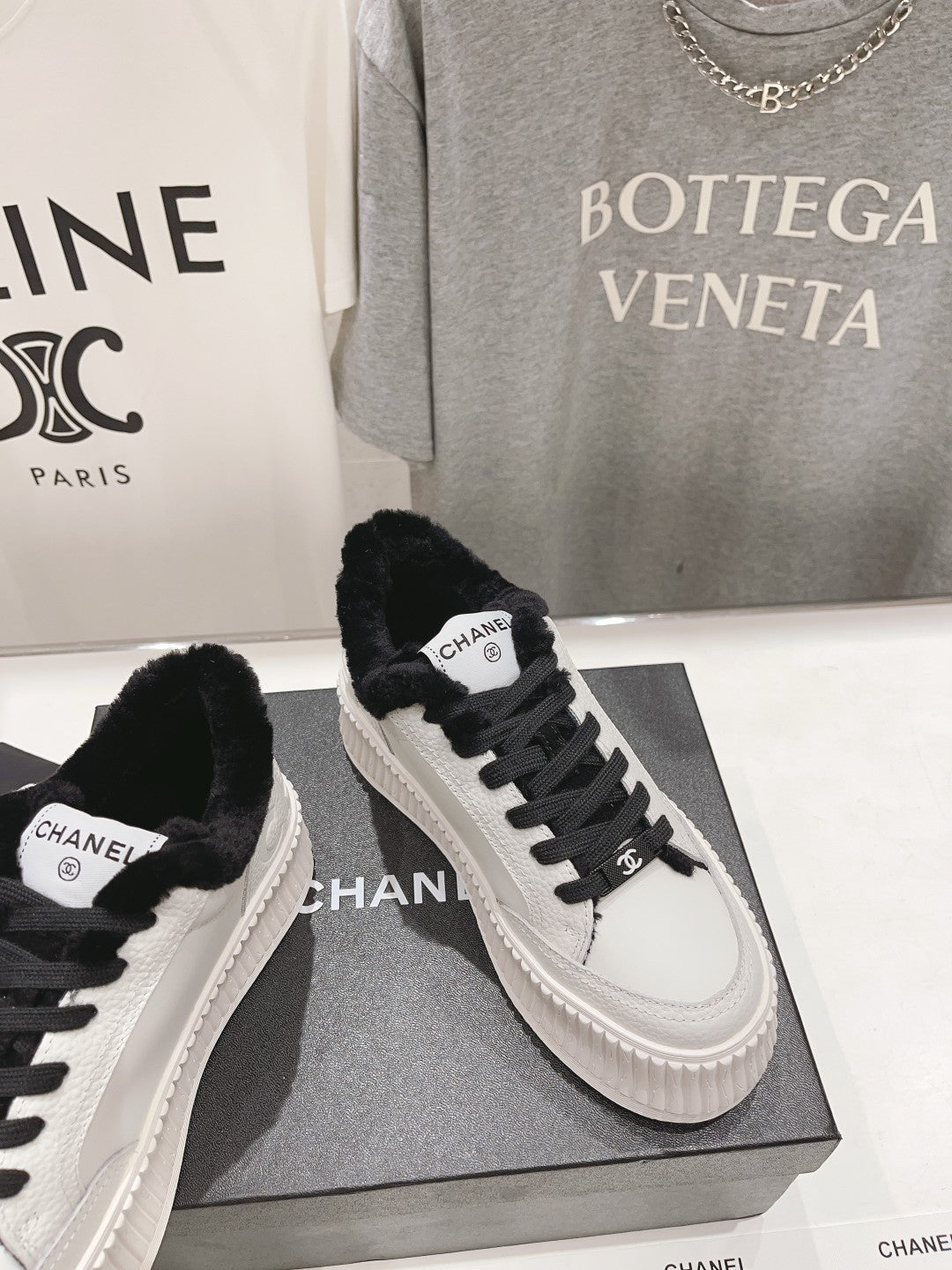 Women’s Chanel sneakers, white leather uppers with black laces and faux-fur collar