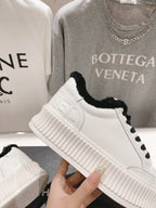 Women’s Chanel sneakers, white side panel with embossed logo and black faux-fur collar
