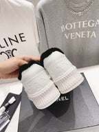 Women’s Chanel sneakers heel close-up, white platform sole with embossed logo panels