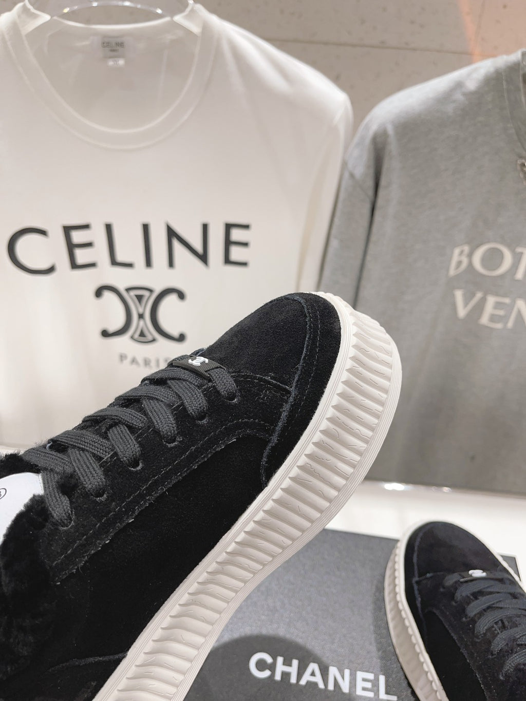 Front side view of black lace-up sneaker with textured white ridged sole