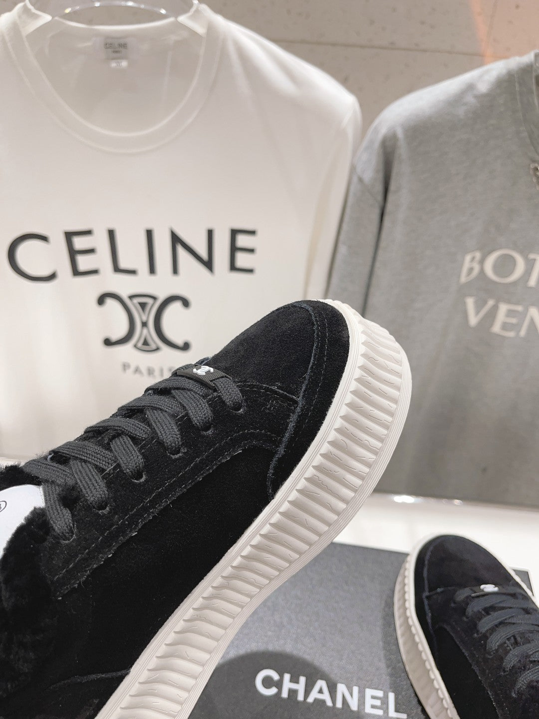 Front side view of black lace-up sneaker with textured white ridged sole