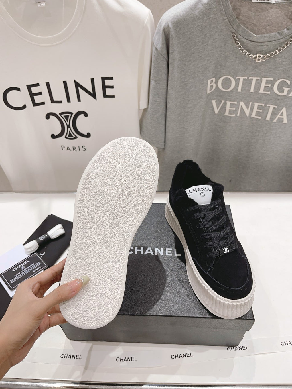 White outsole sole detail for a black lace-up sneaker, with Chanel logo on the shoe