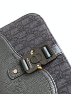 Dior crossbody bag hardware detail with logo plate and snap tab, textured leather