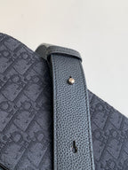 Dior crossbody bag side panel with textured leather edge and metal eyelet