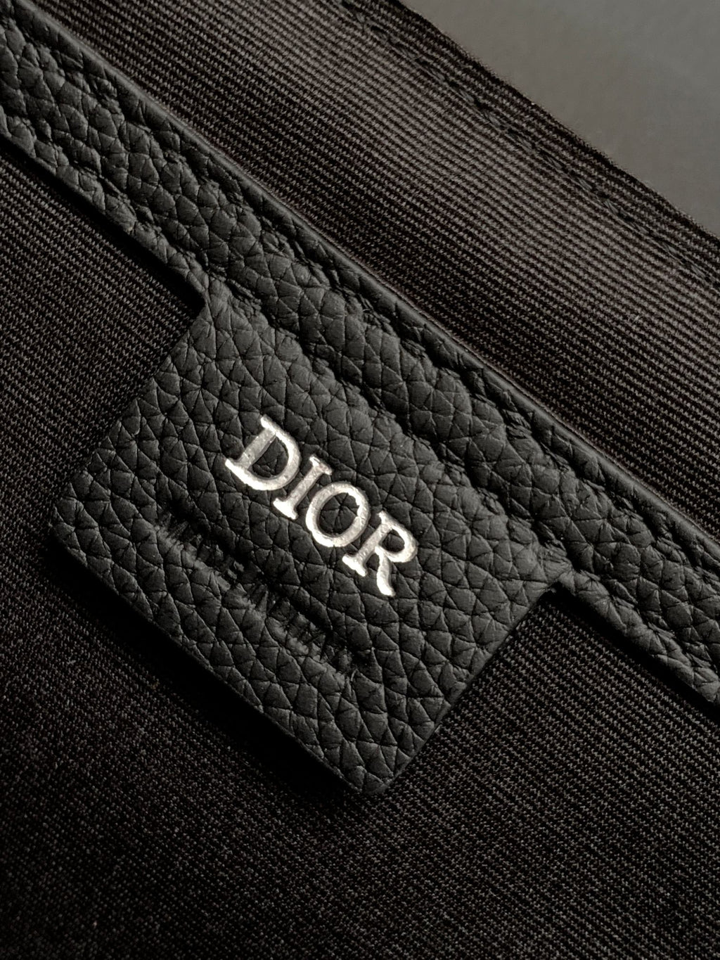 Dior leather pocket detail with Dior embossing on textured front panel