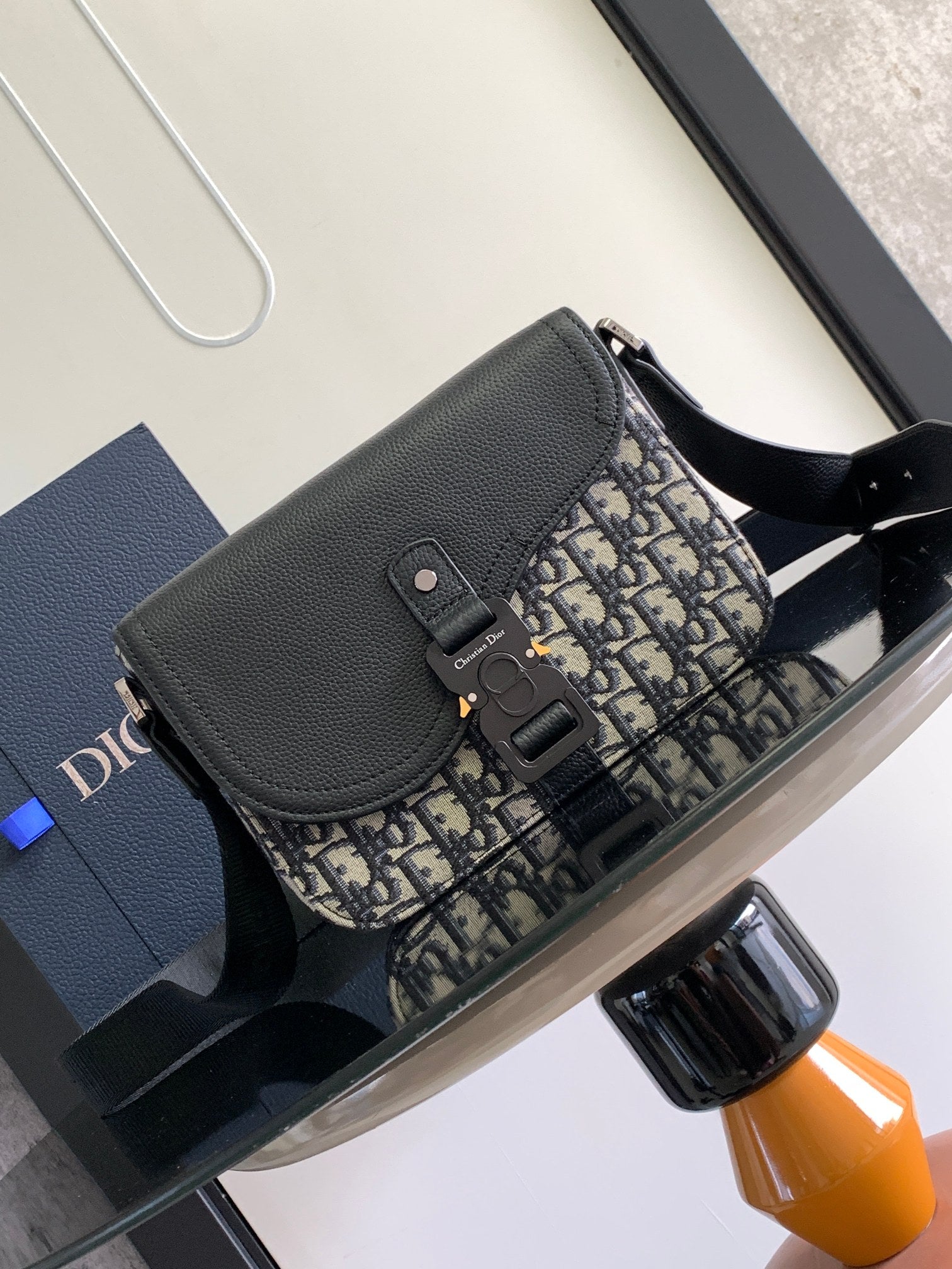 Dior bag with black textured leather flap and Dior monogram canvas front