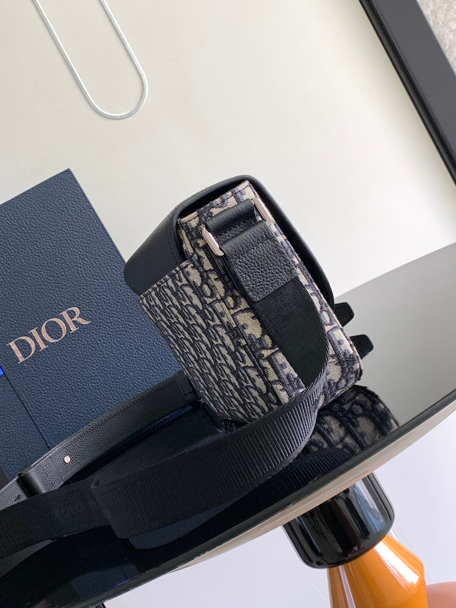 Dior bag top view with black flap and Dior monogram canvas, front buckle