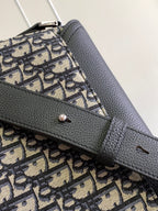 Dior bag close-up: black flap edge with Dior monogram canvas and metal toggle