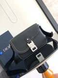Dark textured leather shoulder bag with flap and silver lock hardware