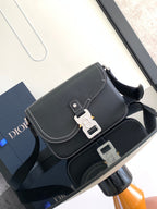 Dark textured leather shoulder bag with flap and silver lock hardware