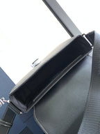 Dark textured leather shoulder bag interior with top flap and metal hardware