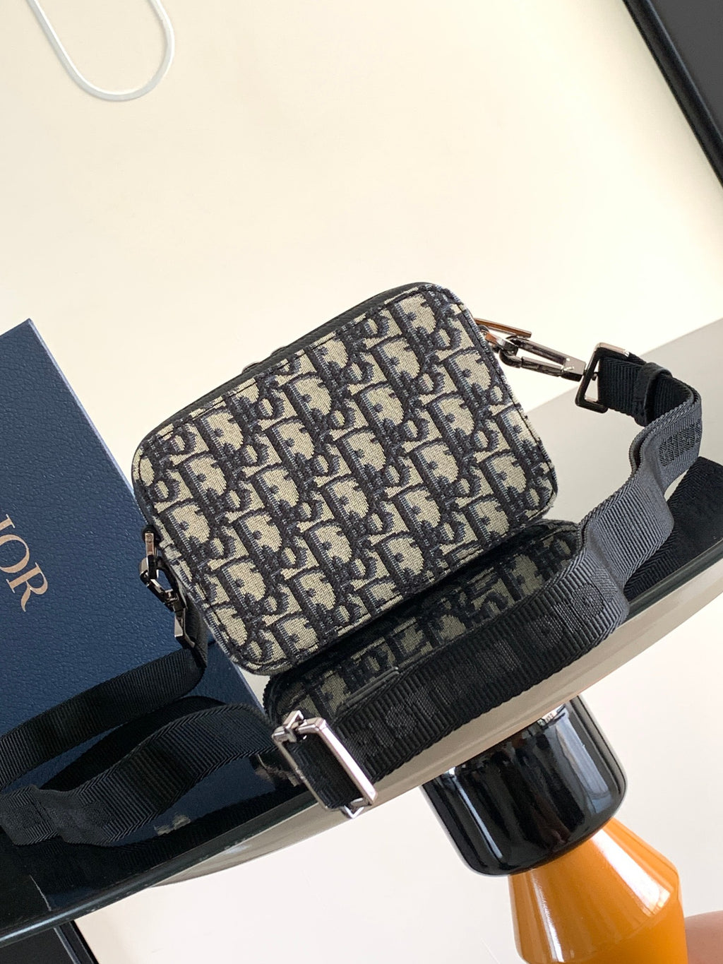 Dior pattern crossbody bag in navy and beige with black trim and silver-tone zipper