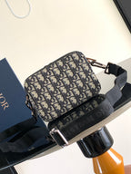 Dior pattern crossbody bag in navy and beige with black trim and silver-tone zipper