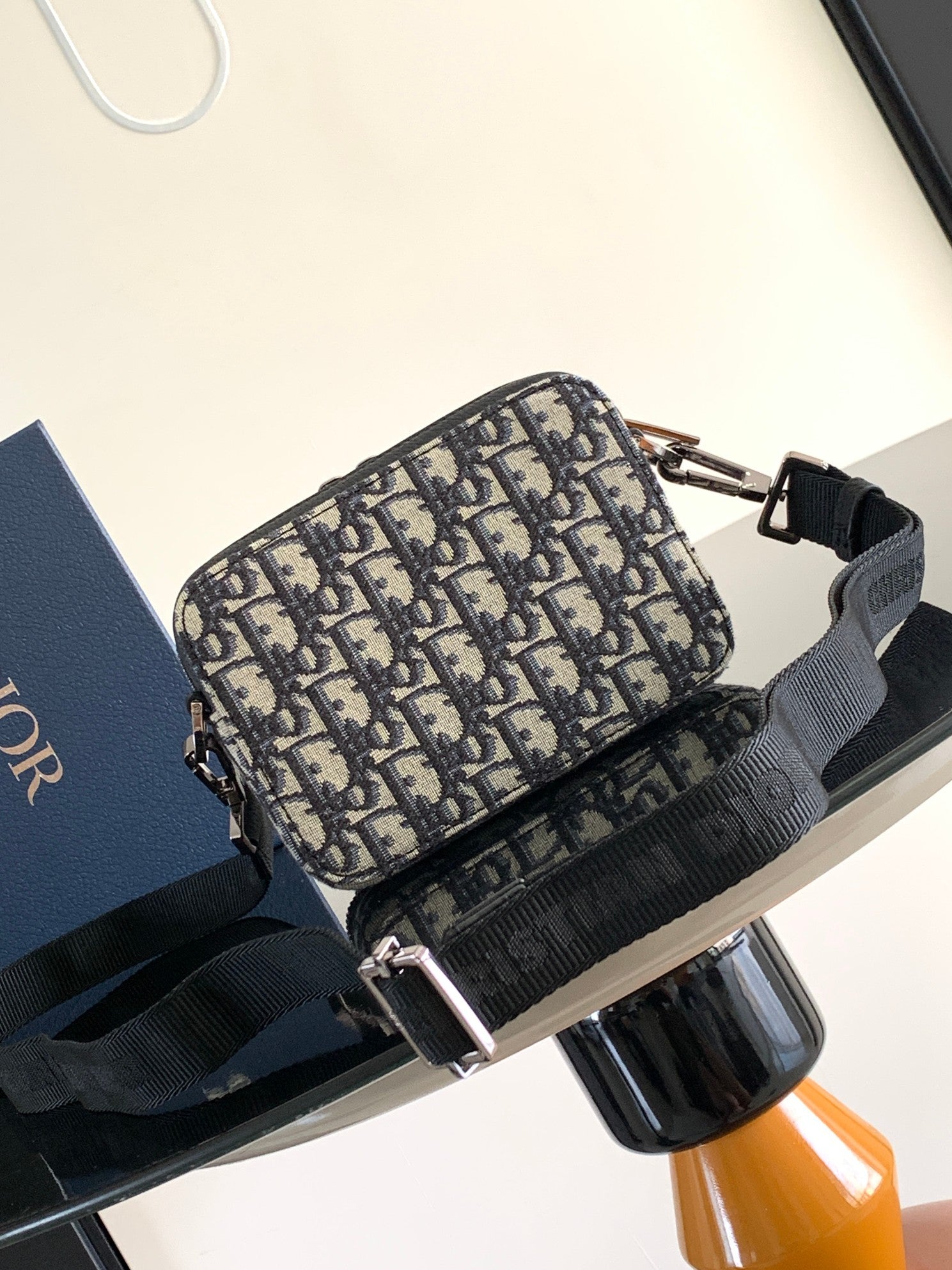 Dior pattern crossbody bag in navy and beige with black trim and silver-tone zipper