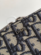Dior pattern bag fabric close-up with “Dior” lettering on woven navy and beige material