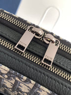Bag detail showing silver-tone zipper track and black leather panel with Dior labels
