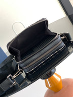 Crossbody bag interior view with black lining and dual zip compartments on patterned exterior