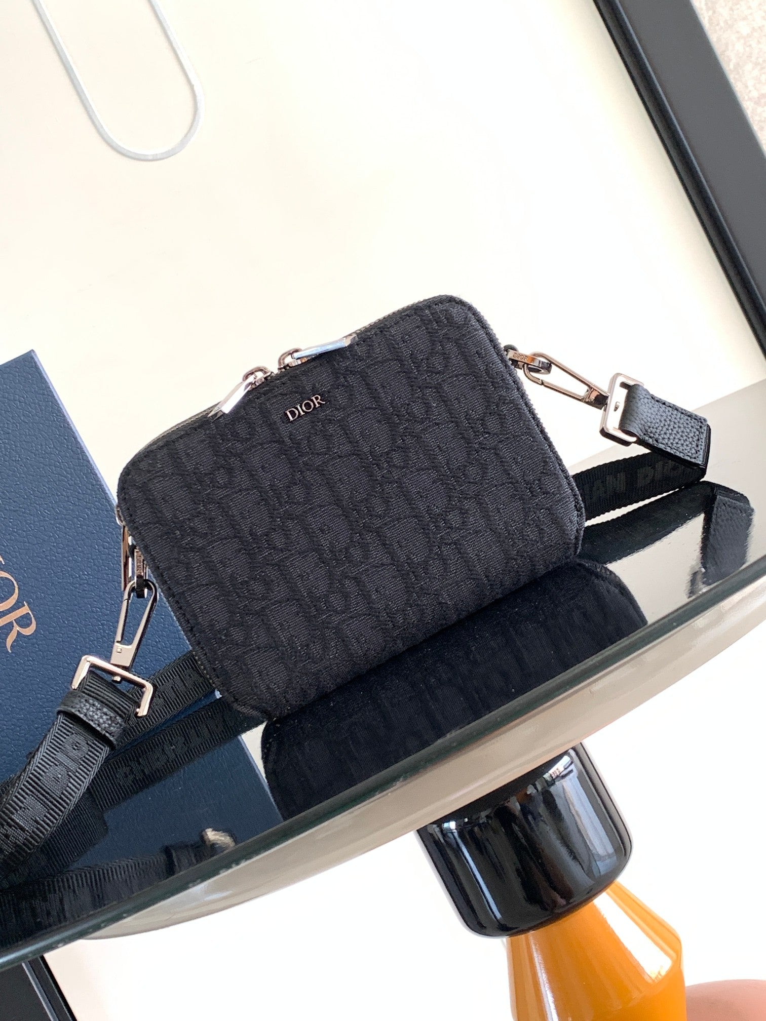 Dior bag in dark navy monogram canvas with dual silver zippers and shoulder strap