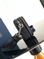 Dior bag dark navy monogram canvas with metal zipper pull and adjustable shoulder strap