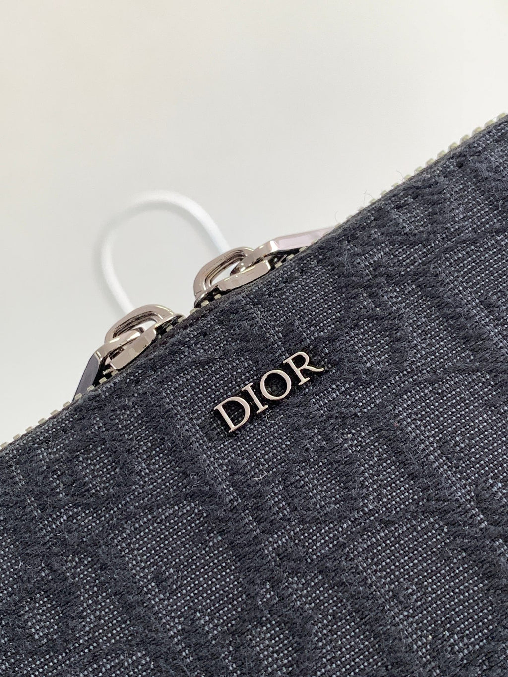 Dior bag dark navy textured fabric with Dior logo emblem and metal zipper rings