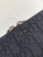 Dior bag dark navy textured fabric with Dior logo emblem and metal zipper rings