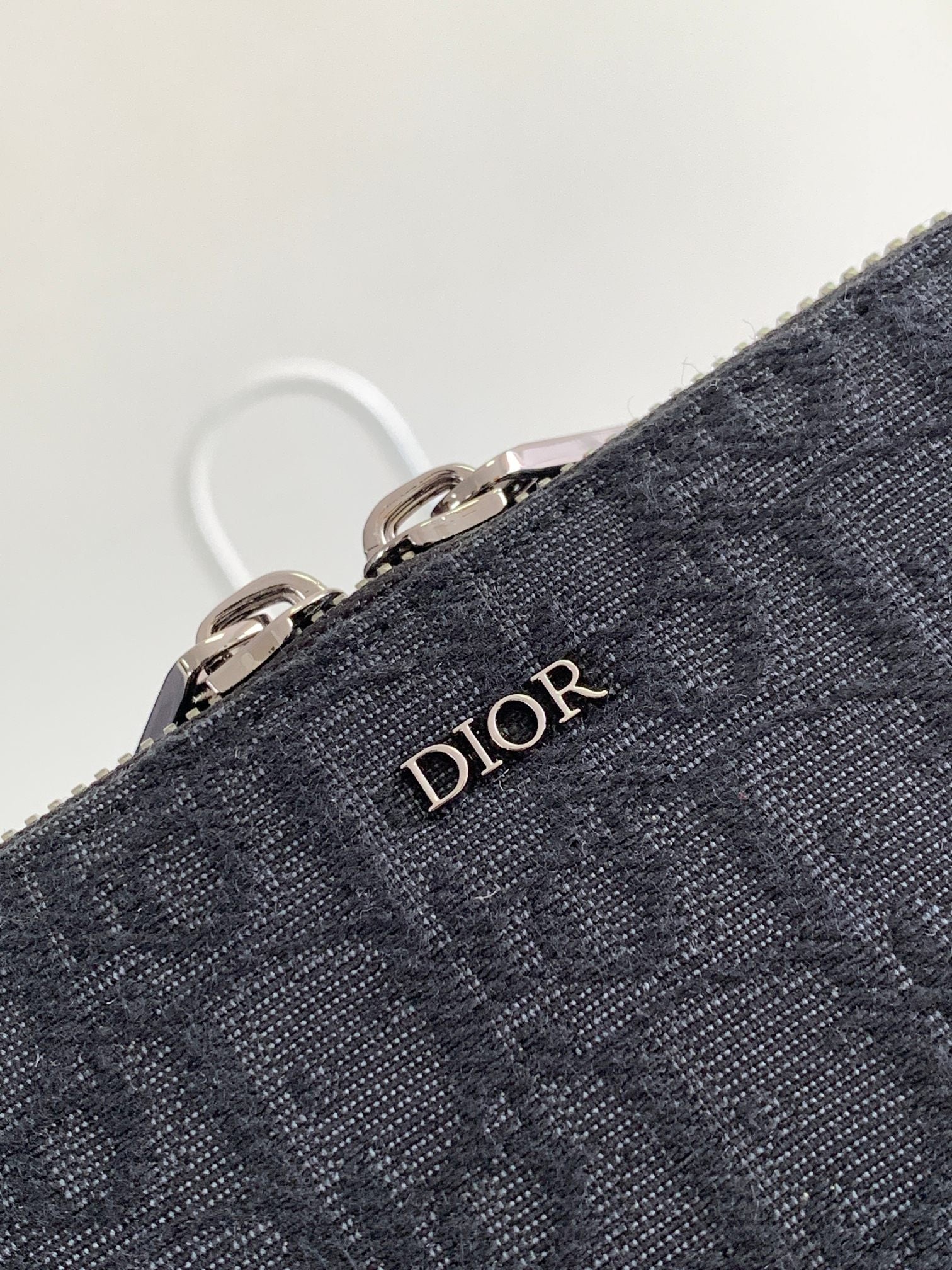 Dior bag dark navy textured fabric with Dior logo emblem and metal zipper rings