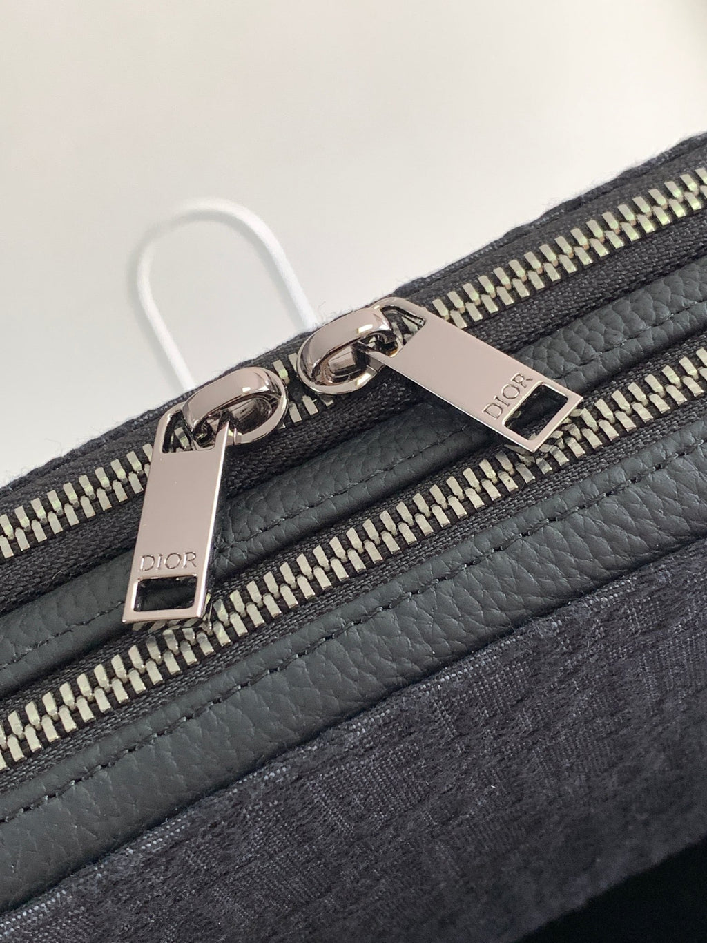 Dior bag dark navy with pebble leather trim and engraved metal zipper pulls