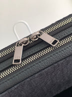 Dior bag dark navy with pebble leather trim and engraved metal zipper pulls