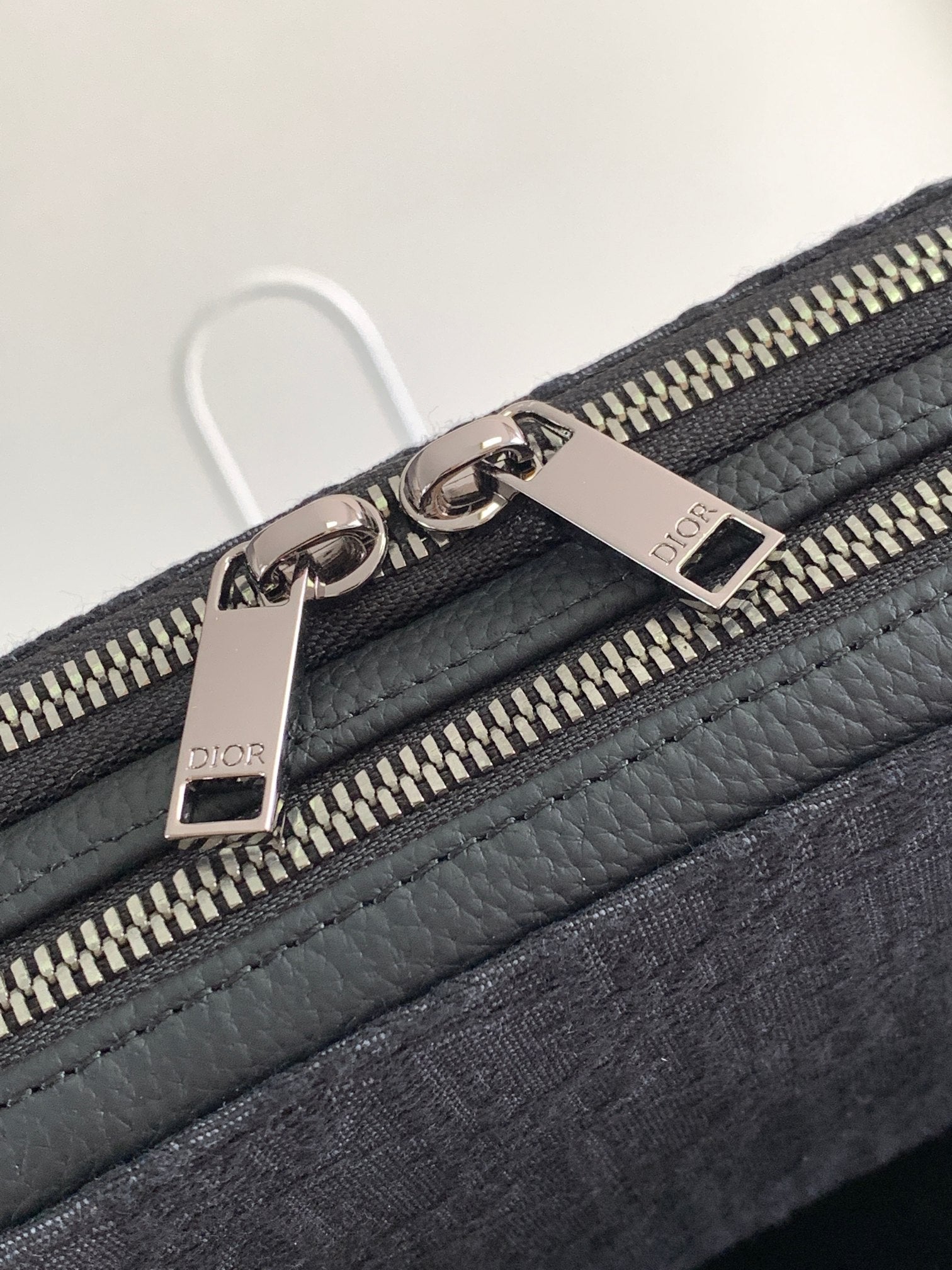 Dior bag dark navy with pebble leather trim and engraved metal zipper pulls