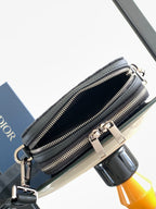 Dior bag dark navy with two zipper compartments and slim strap across body