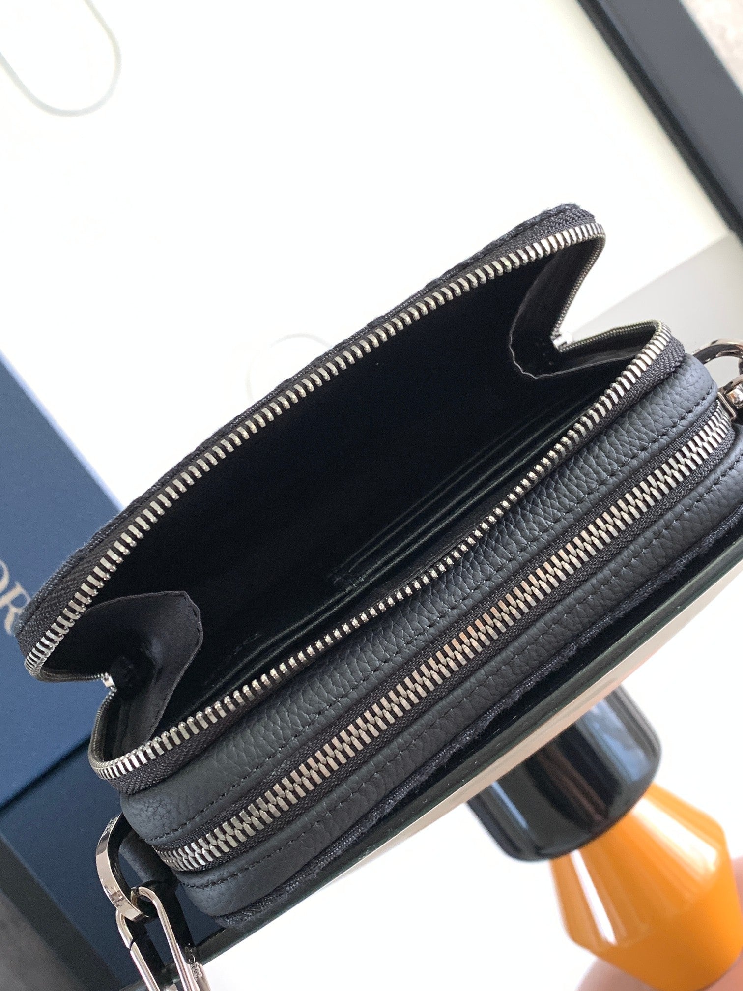 Dior bag dark navy with open top, interior pocket, and double zipper closure