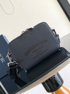 Navy leather Dior crossbody bag with top zipper and front Dior logo, adjustable strap