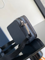 Navy leather crossbody bag with silver zipper, structured front panel, adjustable strap