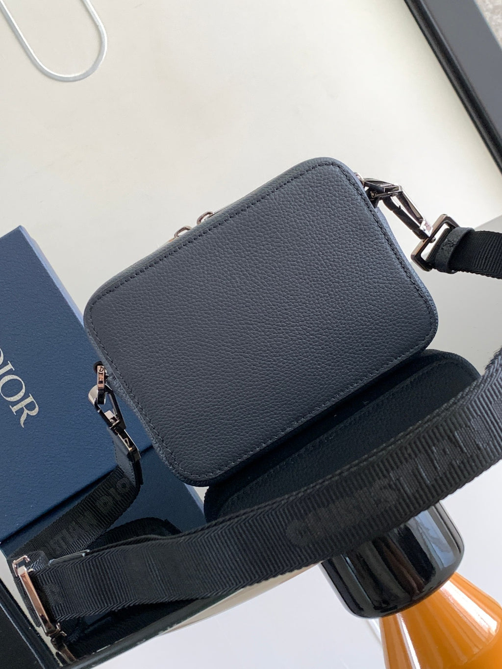 Navy leather crossbody bag with top flap and silver hardware, wide shoulder strap