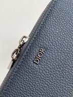 Blue textured leather bag corner with silver zipper hardware and Dior wordmark