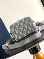 Dior mini crossbody bag with gray Dior Oblique pattern, light blue leather trim, and zip top