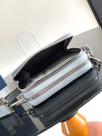 Dior mini bag with multiple zip pockets, light blue leather trim, and dark interior compartments