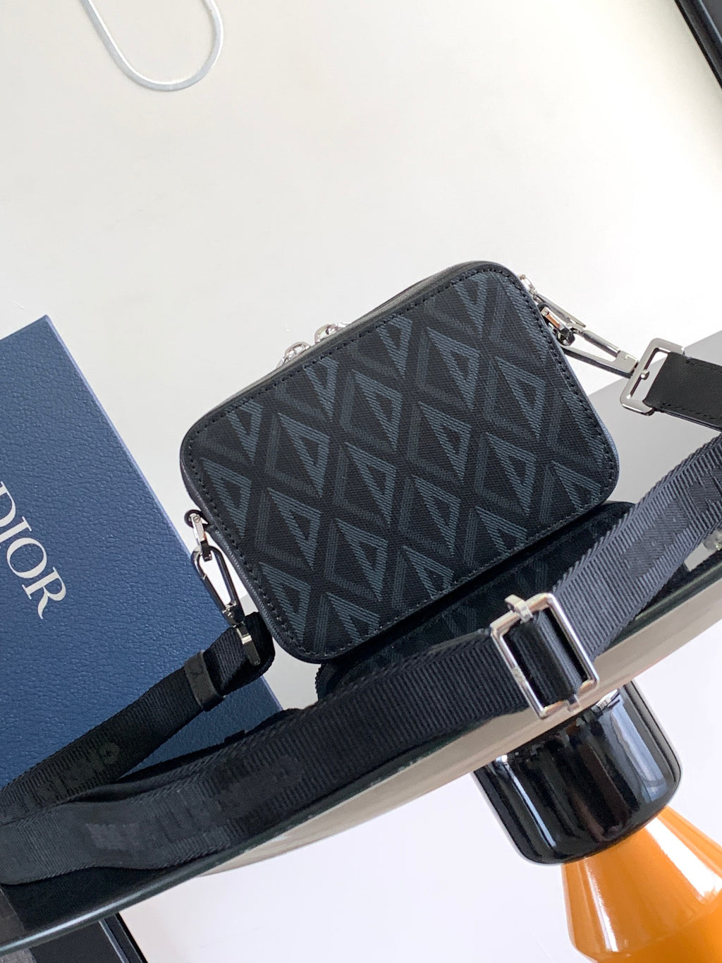 Dark Dior monogram crossbody bag with dual zippers and adjustable shoulder strap