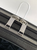 Black leather bag with silver-tone zipper pulls and Dior-engraved hardware