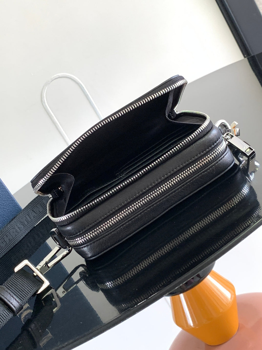 Black crossbody bag with top handle and front zip pockets