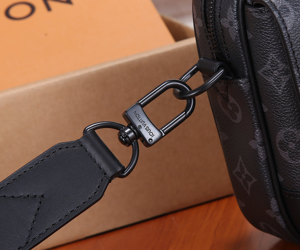 Men's Louis Vuitton crossbody strap attachment with metal rings and leather tabs