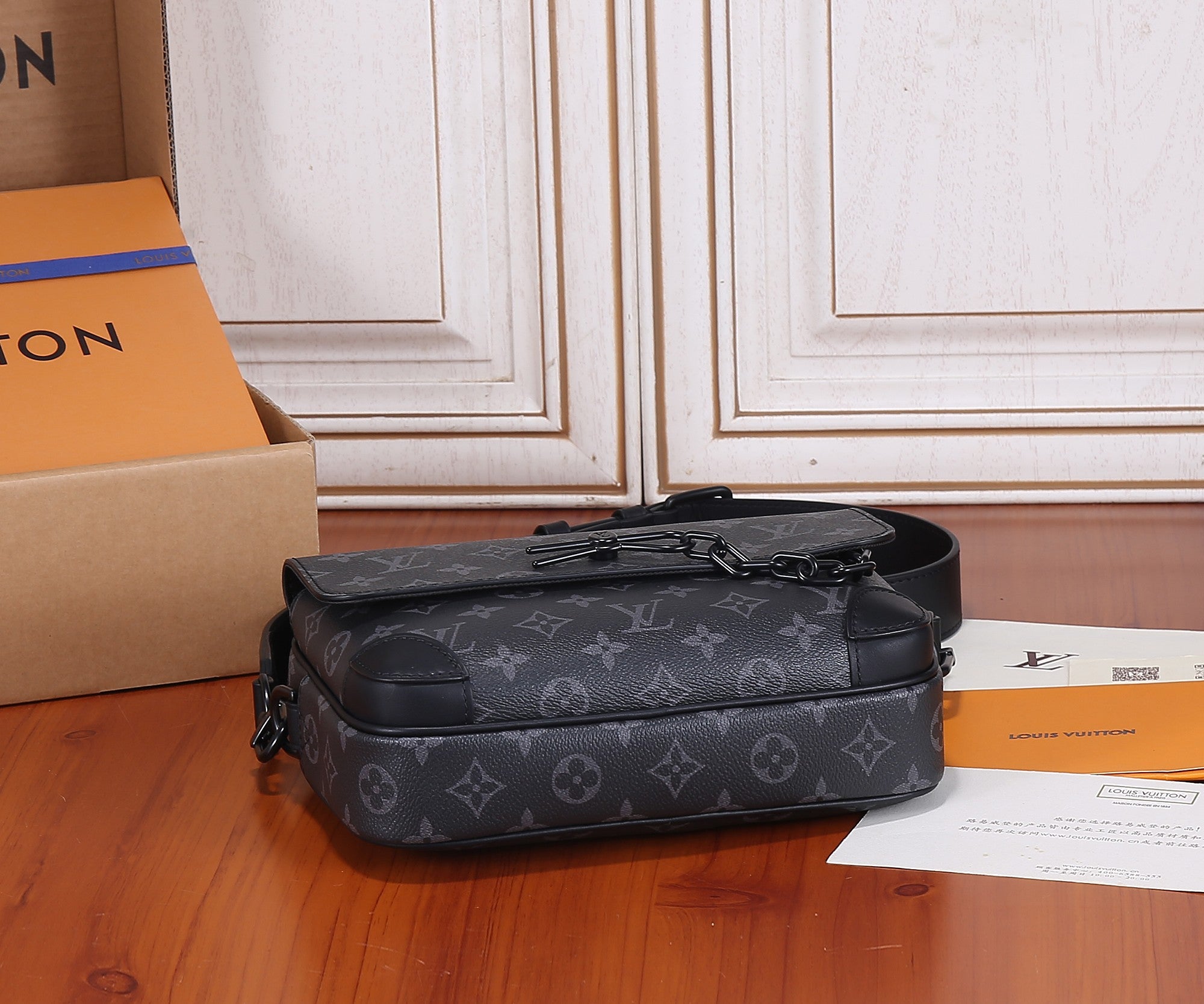 Louis Vuitton monogram crossbody bag, front zipper and chain strap on base