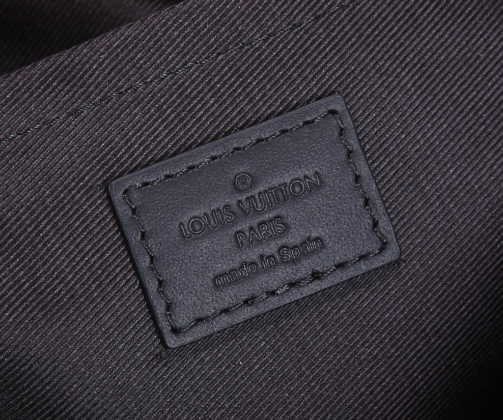Louis Vuitton leather brand label reading “LOUIS VUITTON PARIS” and “made in Spain”