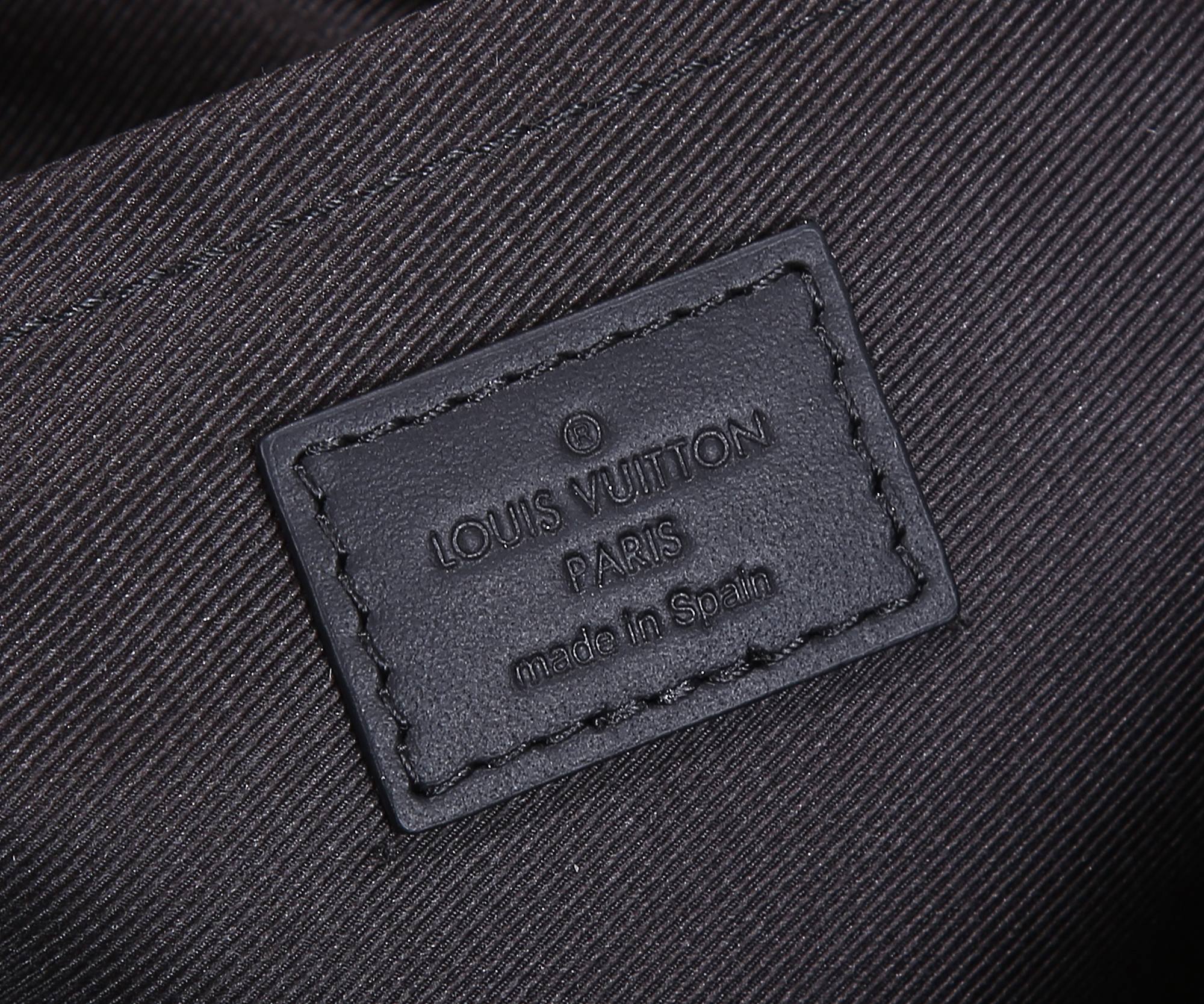 Louis Vuitton leather brand label reading “LOUIS VUITTON PARIS” and “made in Spain”