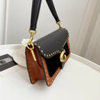 Coah Bags crossbody handbag, black-and-brown panels with gold rings on adjustable strap.