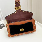 Coah Bags crossbody bag, maroon suede back with brown front, gold stud border and strap.