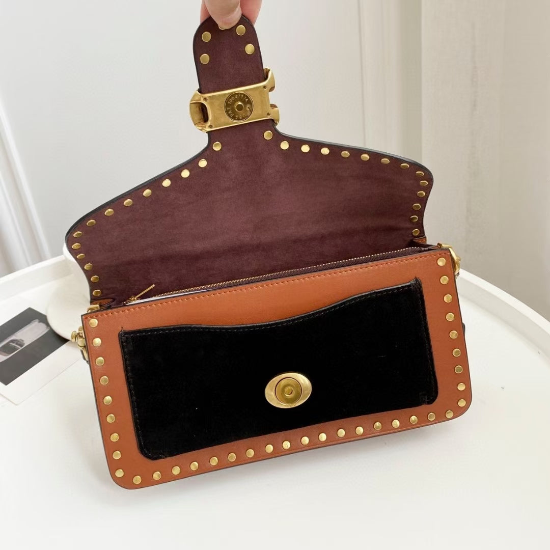 Coah Bags crossbody bag, maroon suede back with brown front, gold stud border and strap.