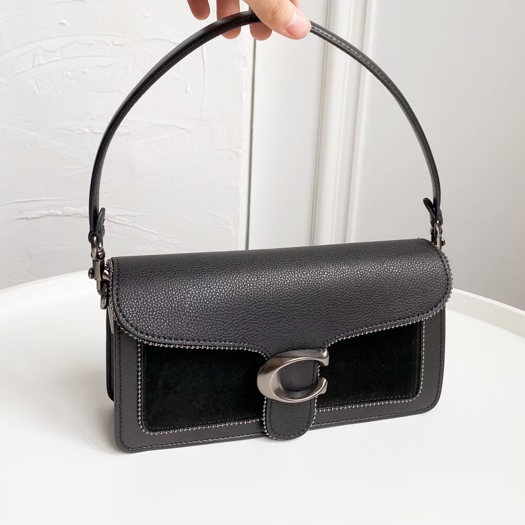 Coah bag with top handle, flap front, silver-tone buckle closure, black exterior