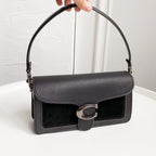 Coah bag with top handle, flap front, silver-tone buckle closure, black exterior